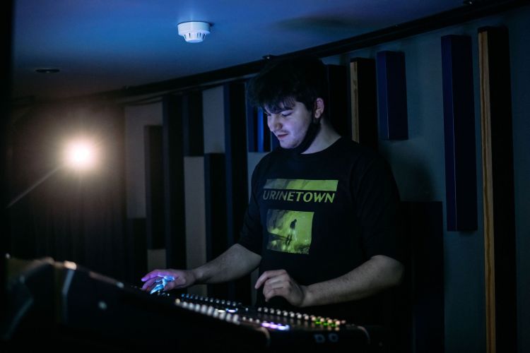 Production Arts student at a sound desk during a rehearsal